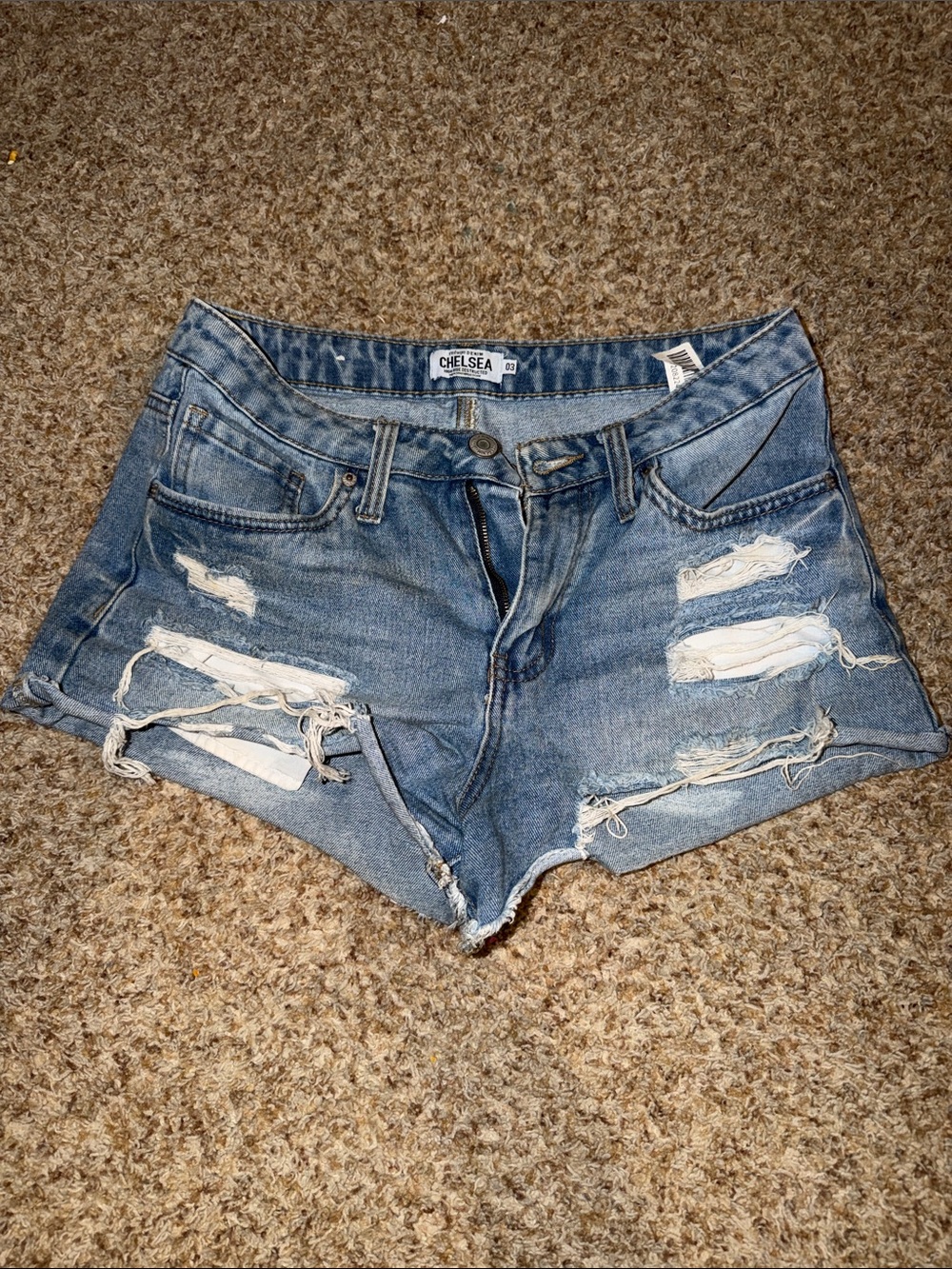 Chelsea brand light wash denim shorts with heavy distressing and frayed hems